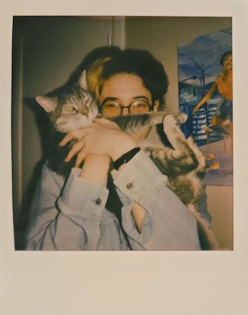 Polaroid photo of me holding my cat Deeby